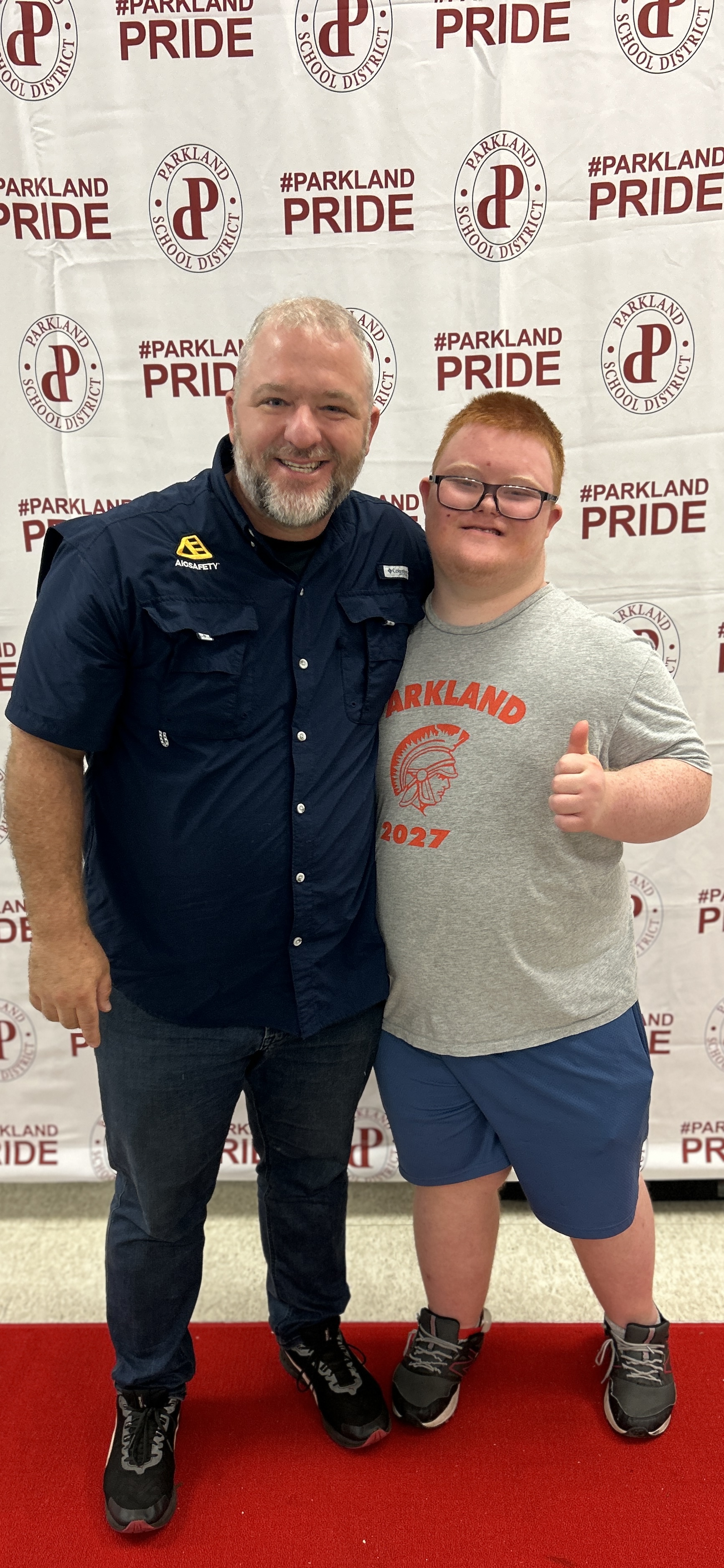 Bobby Lanyon and his son Jack at Parkland School District — Jack giving a thumbs up